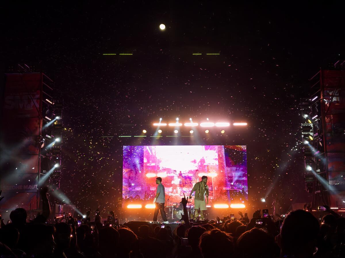 Massive concert crowd under stage lights