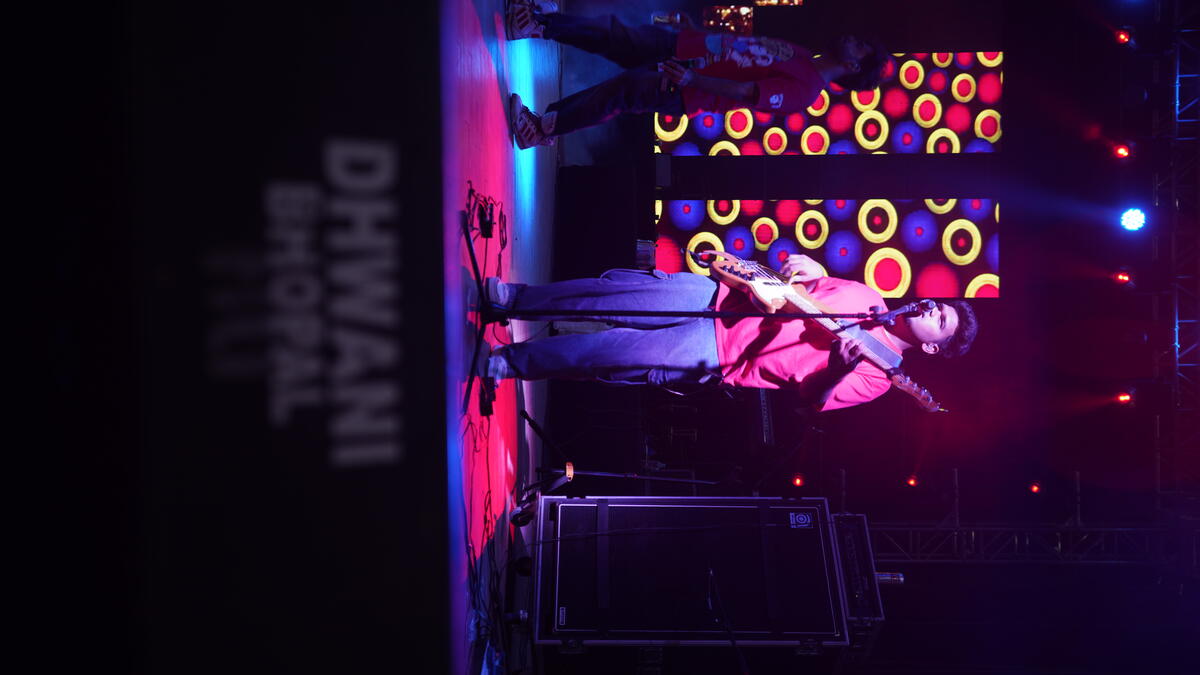 Festival crowd with colourful stage lighting at night