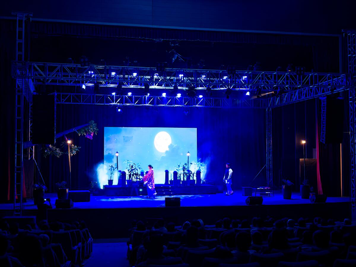 Outdoor festival staging with weather protection and crowd barriers